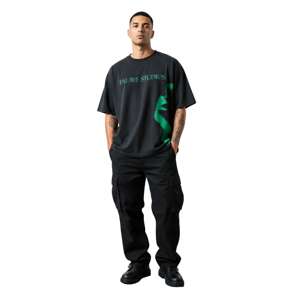 Person wearing a black t-shirt with a graphic design and text, standing against a white background.